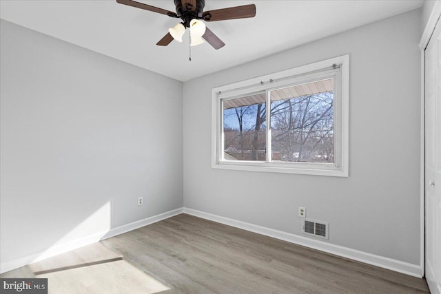 spare room featuring hardwood / wood-style flooring and ceiling fan