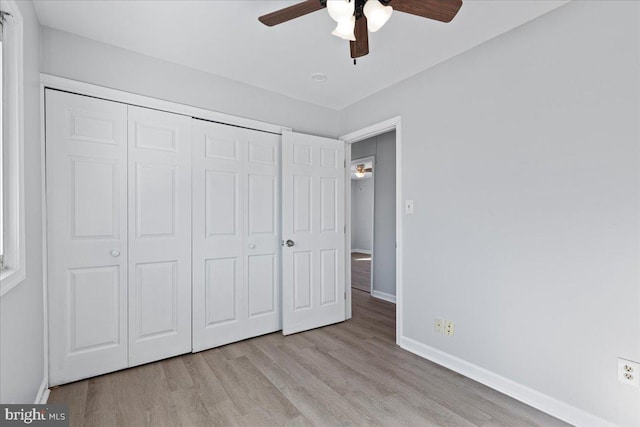 unfurnished bedroom featuring light hardwood / wood-style flooring, a closet, and ceiling fan