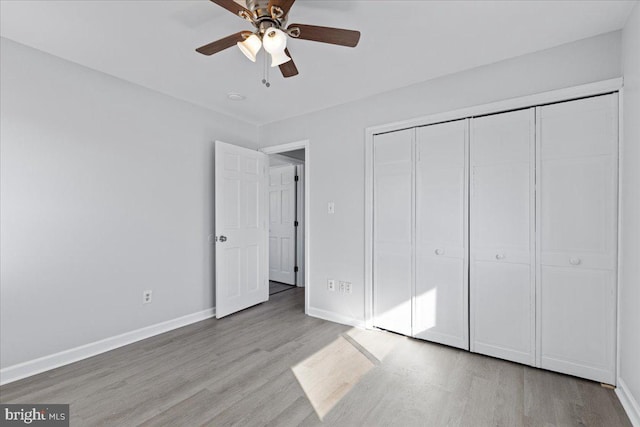 unfurnished bedroom featuring a closet, ceiling fan, and light wood-type flooring