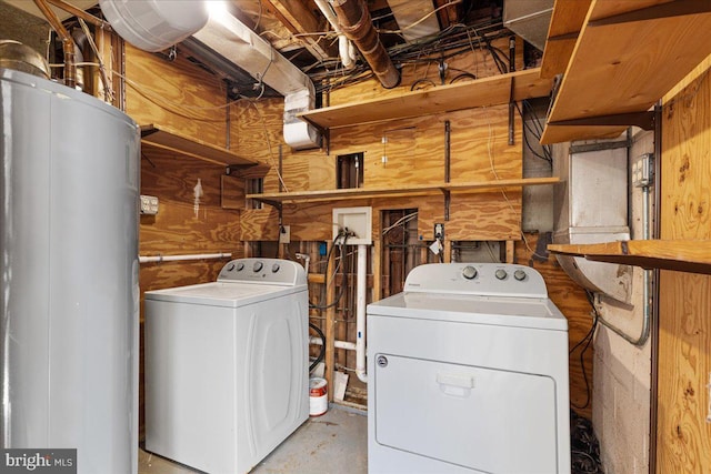 washroom featuring wooden walls and washer and dryer