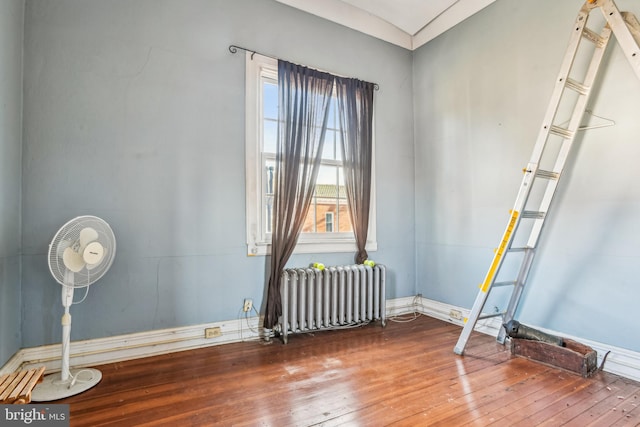 empty room with radiator and wood-type flooring