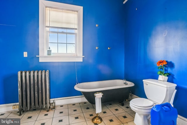 bathroom with a washtub, radiator, a baseboard radiator, tile patterned floors, and toilet