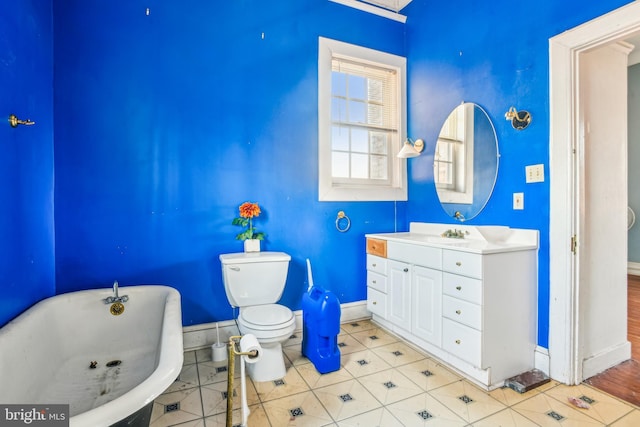 bathroom featuring vanity, a bath, tile patterned floors, and toilet