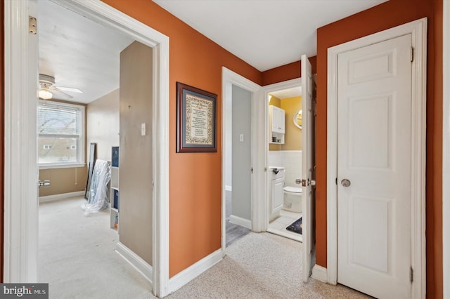 hall featuring light colored carpet