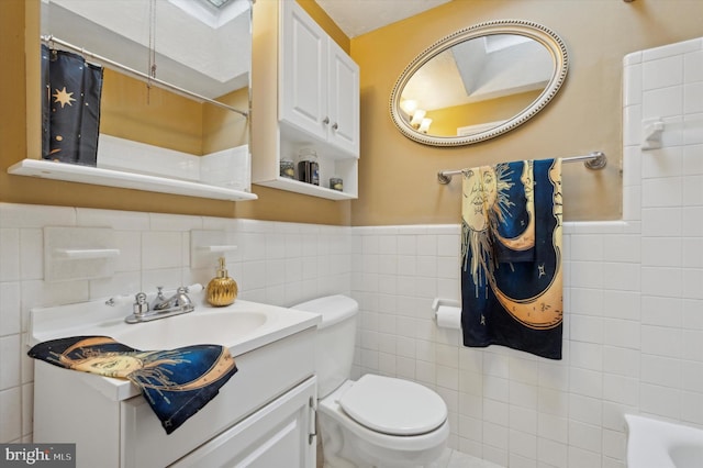 bathroom featuring vanity, curtained shower, tile walls, and toilet