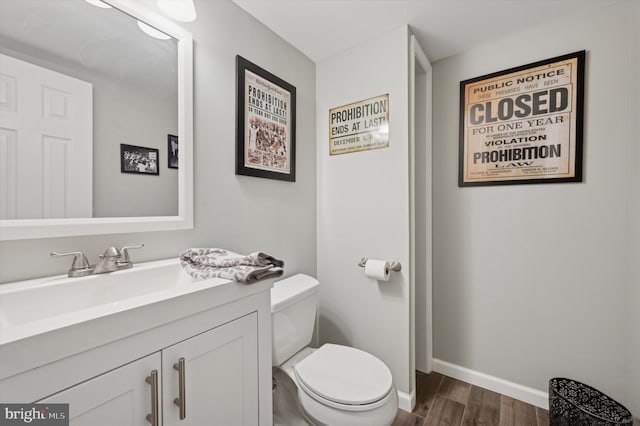 bathroom featuring vanity, hardwood / wood-style floors, and toilet