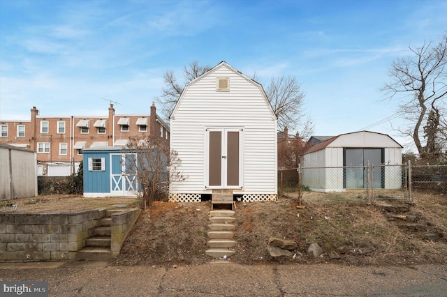 back of property featuring a shed