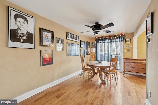 dining space with light hardwood / wood-style floors and ceiling fan