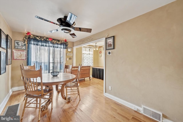 dining space with ceiling fan, radiator, and light hardwood / wood-style floors