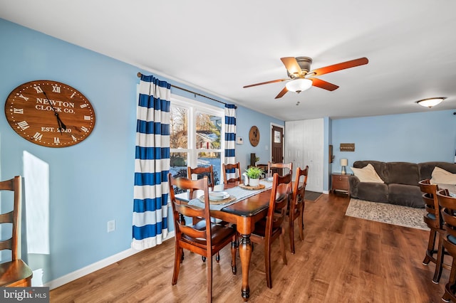 dining area featuring dark wood-type flooring and ceiling fan