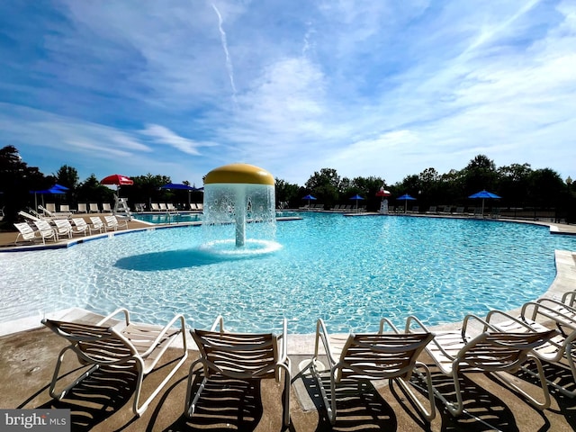 view of swimming pool with pool water feature