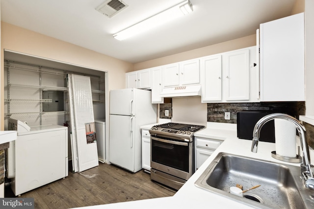 kitchen with white refrigerator, stainless steel range with gas cooktop, sink, and white cabinets