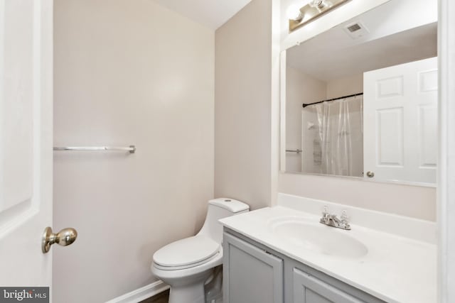 bathroom featuring vanity, a shower with curtain, and toilet