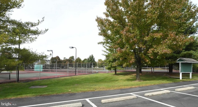 exterior space featuring a yard and tennis court