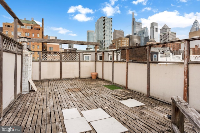 wooden terrace featuring a city view