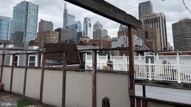 exterior space featuring a view of city and fence