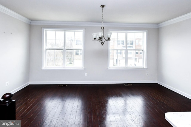 unfurnished dining area featuring dark hardwood / wood-style flooring, crown molding, and plenty of natural light