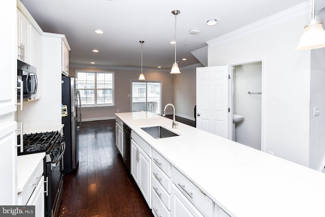 kitchen with sink, dark wood-type flooring, white cabinetry, hanging light fixtures, and stainless steel appliances