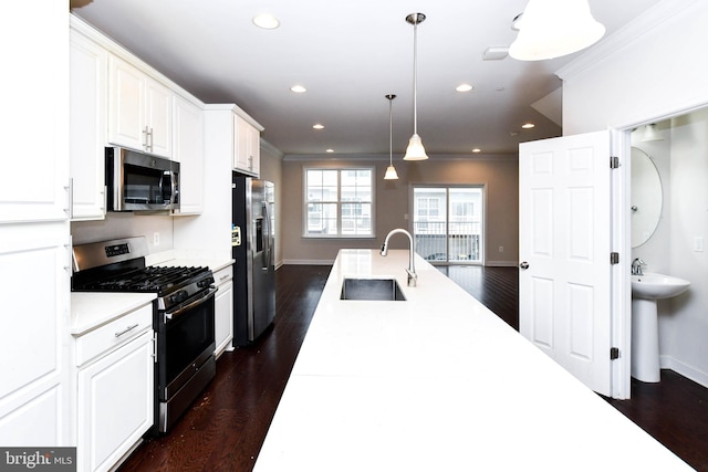 kitchen with dark wood-type flooring, sink, white cabinetry, decorative light fixtures, and stainless steel appliances