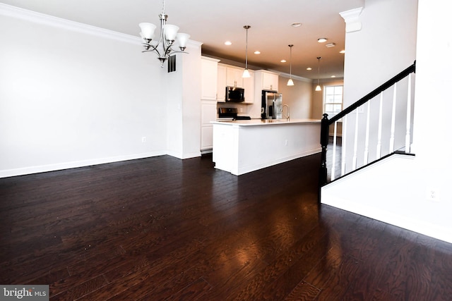 kitchen featuring an island with sink, white cabinets, hanging light fixtures, stove, and stainless steel fridge with ice dispenser