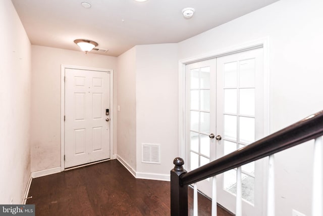 entrance foyer with french doors and dark hardwood / wood-style floors