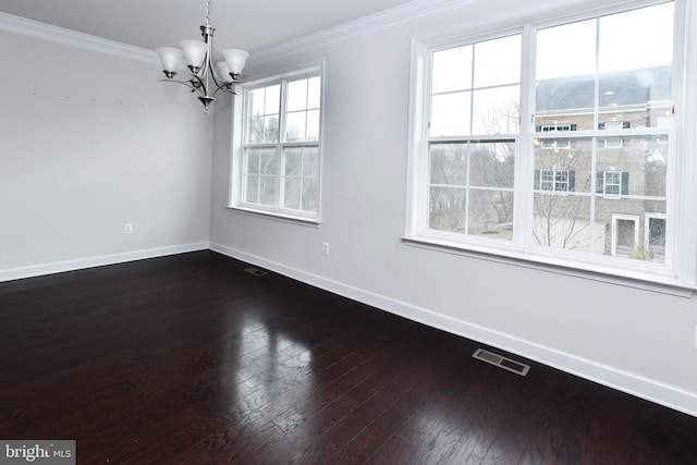 unfurnished room with crown molding, an inviting chandelier, and dark wood-type flooring