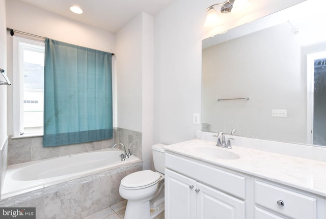 bathroom featuring tiled tub, vanity, tile patterned floors, and toilet