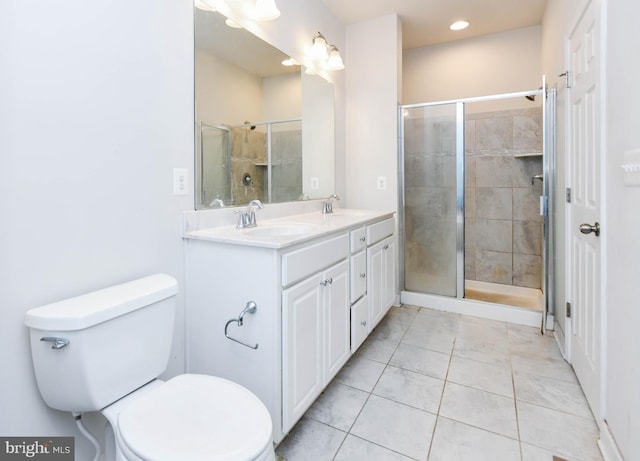 bathroom featuring vanity, a shower with shower door, and toilet