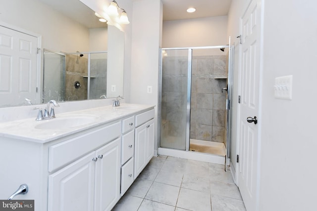 bathroom with vanity, an enclosed shower, and tile patterned floors