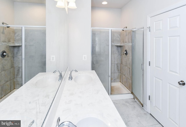 bathroom featuring walk in shower, tile patterned floors, and vanity