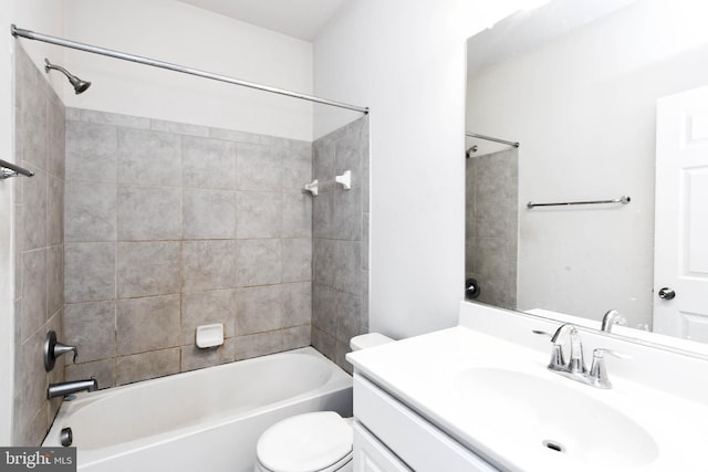 full bathroom with vanity, toilet, and tiled shower / bath