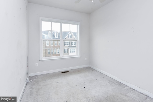 unfurnished room featuring ceiling fan and light colored carpet