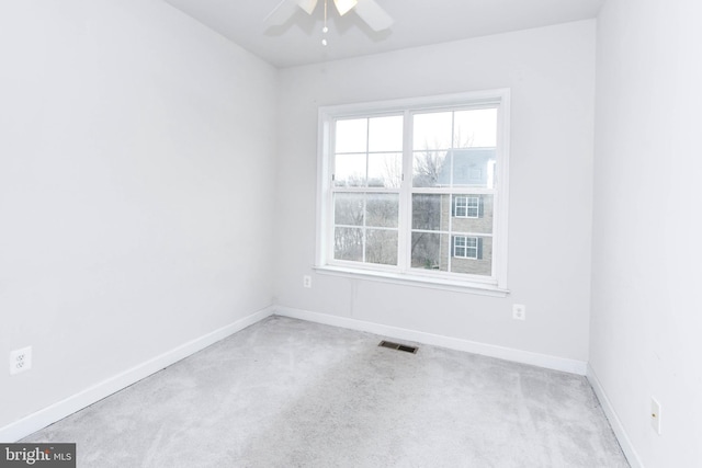 carpeted empty room featuring ceiling fan