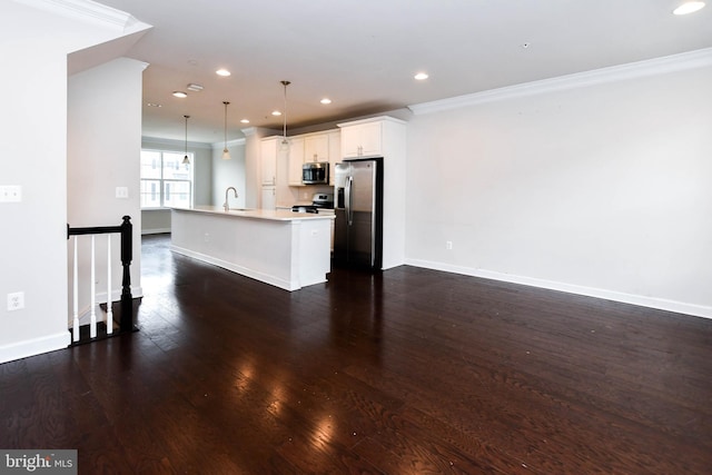 kitchen featuring appliances with stainless steel finishes, dark hardwood / wood-style floors, decorative light fixtures, an island with sink, and white cabinets