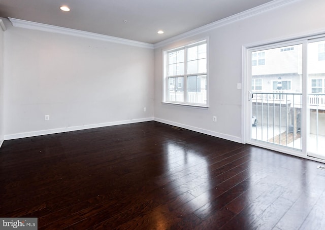 empty room with ornamental molding and dark hardwood / wood-style flooring