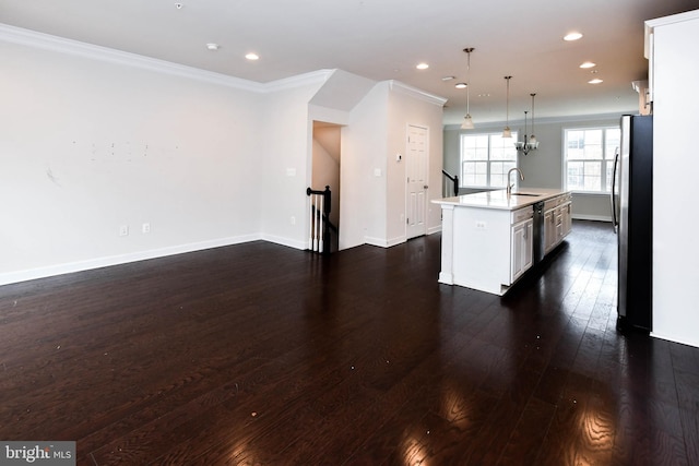 kitchen with sink, decorative light fixtures, a center island with sink, stainless steel fridge, and dark hardwood / wood-style flooring