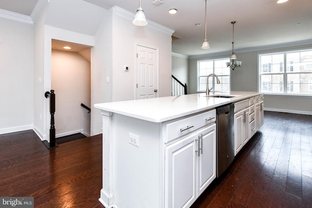 kitchen with sink, hanging light fixtures, stainless steel dishwasher, ornamental molding, and an island with sink