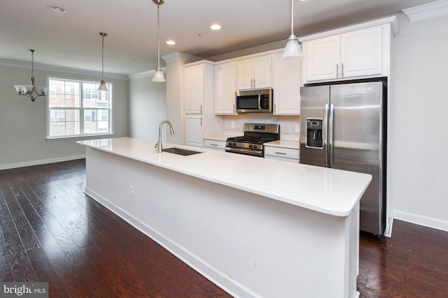 kitchen with sink, crown molding, appliances with stainless steel finishes, a kitchen island with sink, and white cabinets