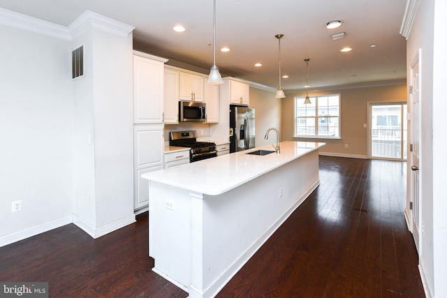 kitchen featuring a spacious island, sink, white cabinetry, pendant lighting, and stainless steel appliances