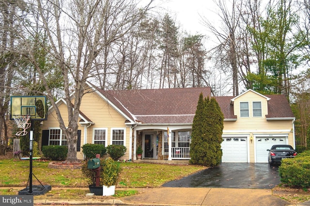 view of front of home featuring aphalt driveway, a front lawn, and a shingled roof