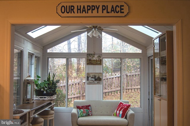 sunroom / solarium featuring lofted ceiling with skylight and a ceiling fan