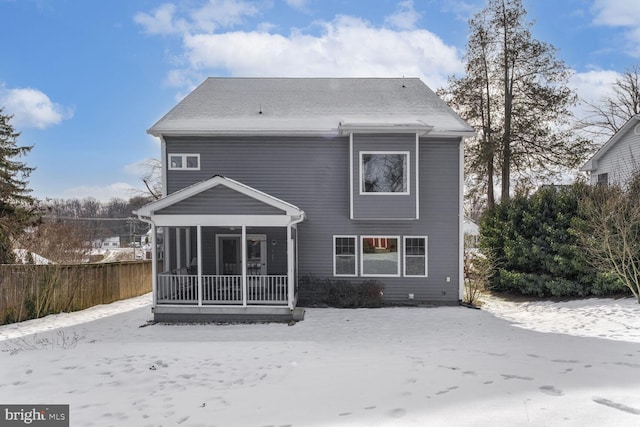 rear view of property featuring fence and a sunroom