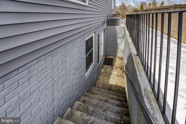 view of side of home featuring fence