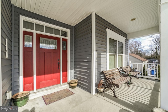 view of exterior entry featuring covered porch