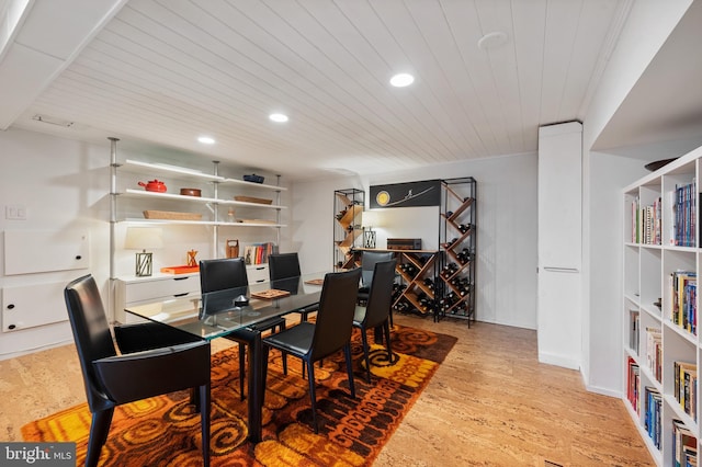 dining area with wood ceiling and light hardwood / wood-style flooring