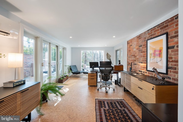 office space with an AC wall unit, french doors, and brick wall