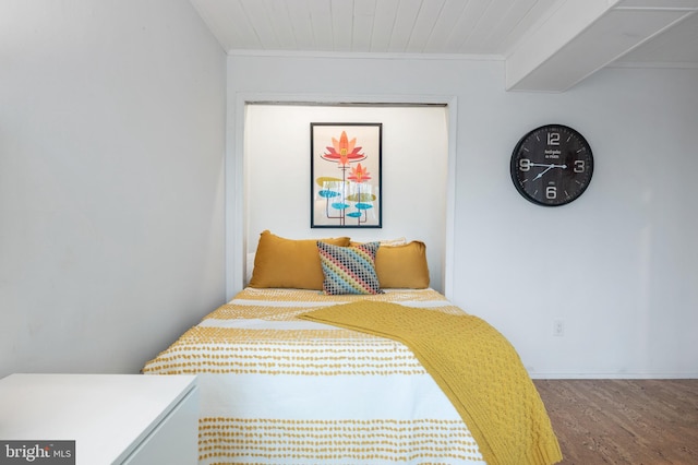 bedroom featuring crown molding and hardwood / wood-style floors