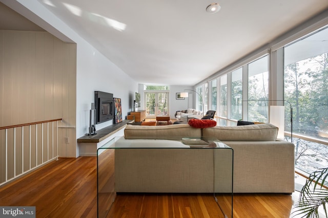 living room featuring wood-type flooring and floor to ceiling windows