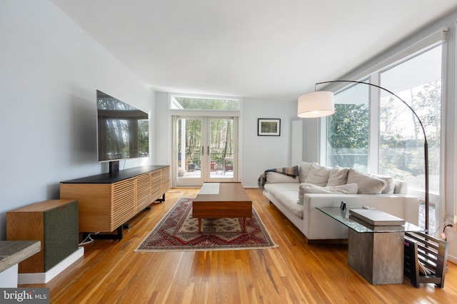 living room featuring french doors and light hardwood / wood-style floors