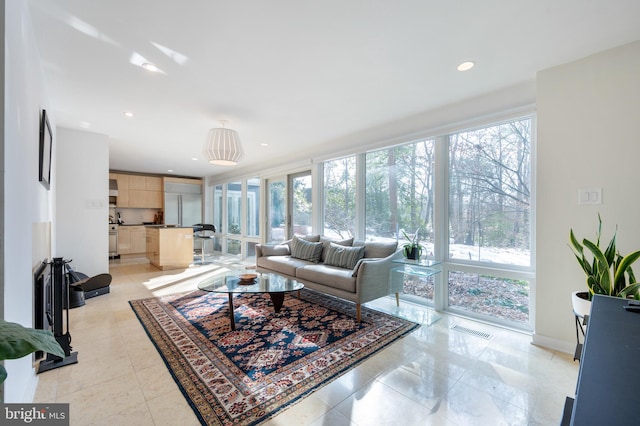 living room featuring a wall of windows